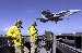    	

050706-N-6781S-037 Pacific Ocean (July 6, 2005) ? Lt. Tony Myers and Lt. Derecy Brown stand watch as an F/A-18E Super Hornet, assigned to the ?Tophatters? of Strike Fighter Squadron One Four (VFA-14), conducts a ?wave-off? over the flight deck aboard the nuclear-powered aircraft carrier USS Nimitz (CVN 68). The Nimitz Strike Group is currently on a regularly scheduled deployment in support of the Global War on Terrorism. U.S. Navy photo by Photographer?s Mate 3rd Class Elisabeth Ann Saccotelli (RELEASED) 

Here is Tony and Derek Doo Doo Brown live and in action on the USS Nimitz.  Photo is for some Navy PR deal for its sailors.